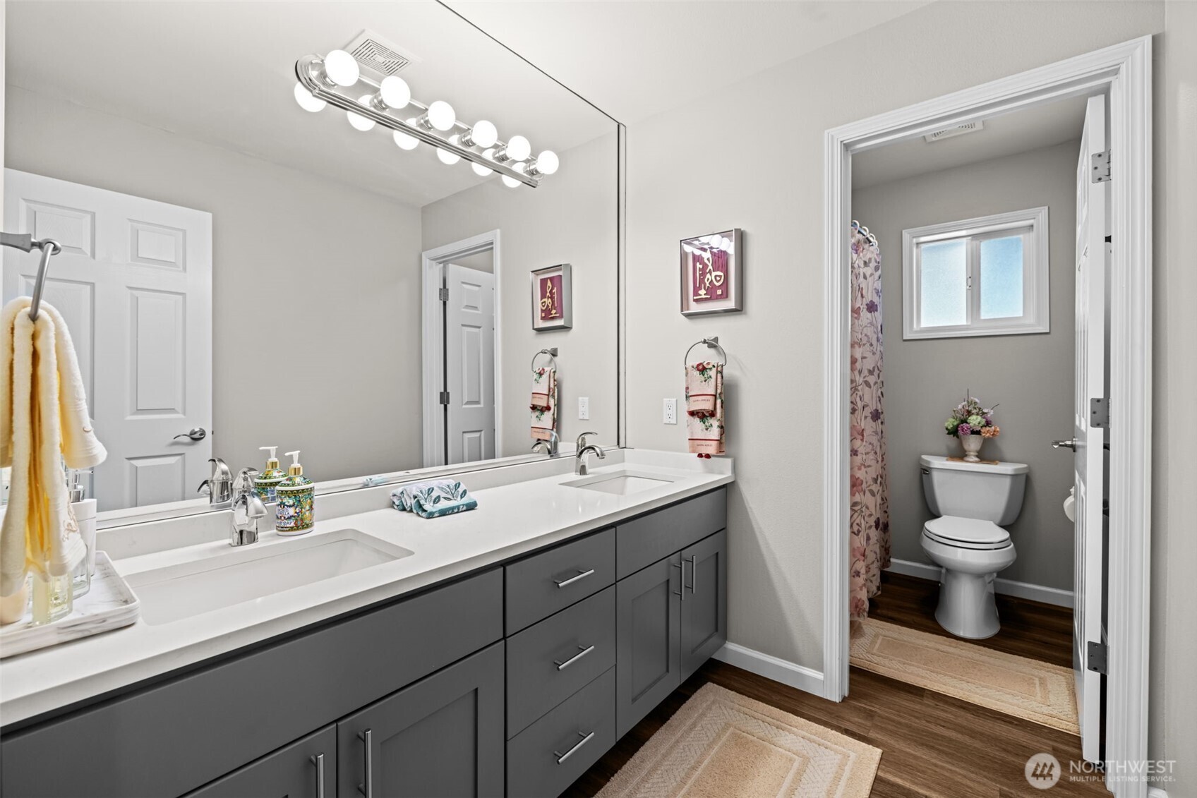 Up[dated full bath dual sink vanity, white 6 panel doors, & separate lavatory.