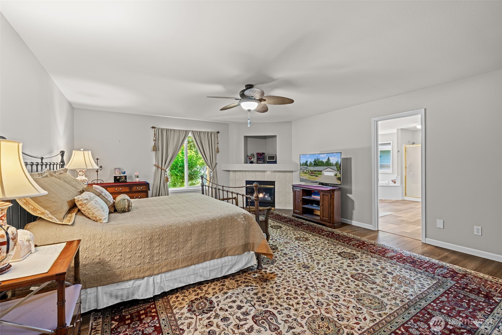 Double doors to spacious primary retreat with fireplace and full bath en suite.