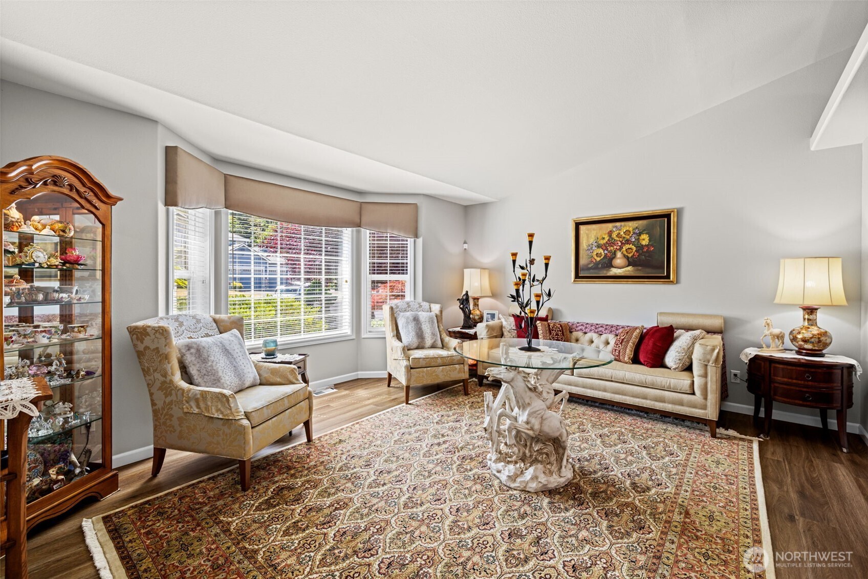 Living room with bay window and cornice board framed accent.