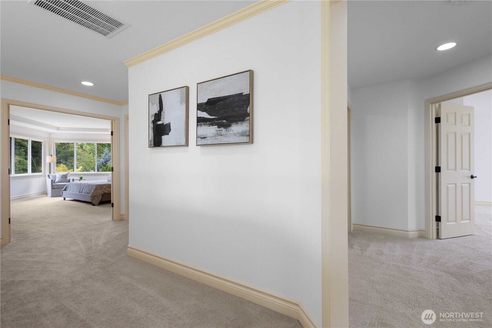 Bright and inviting landing with plush carpeting and graceful architectural details—connecting upper-level bedrooms.