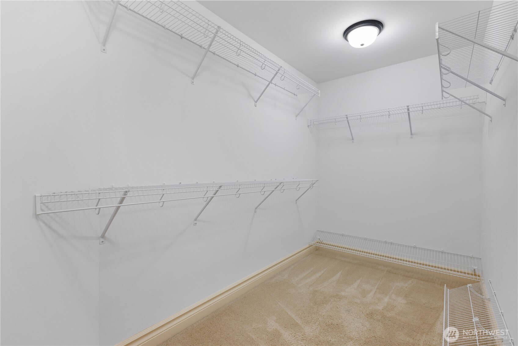 Large walk-in closet offers storage and built-in organization.