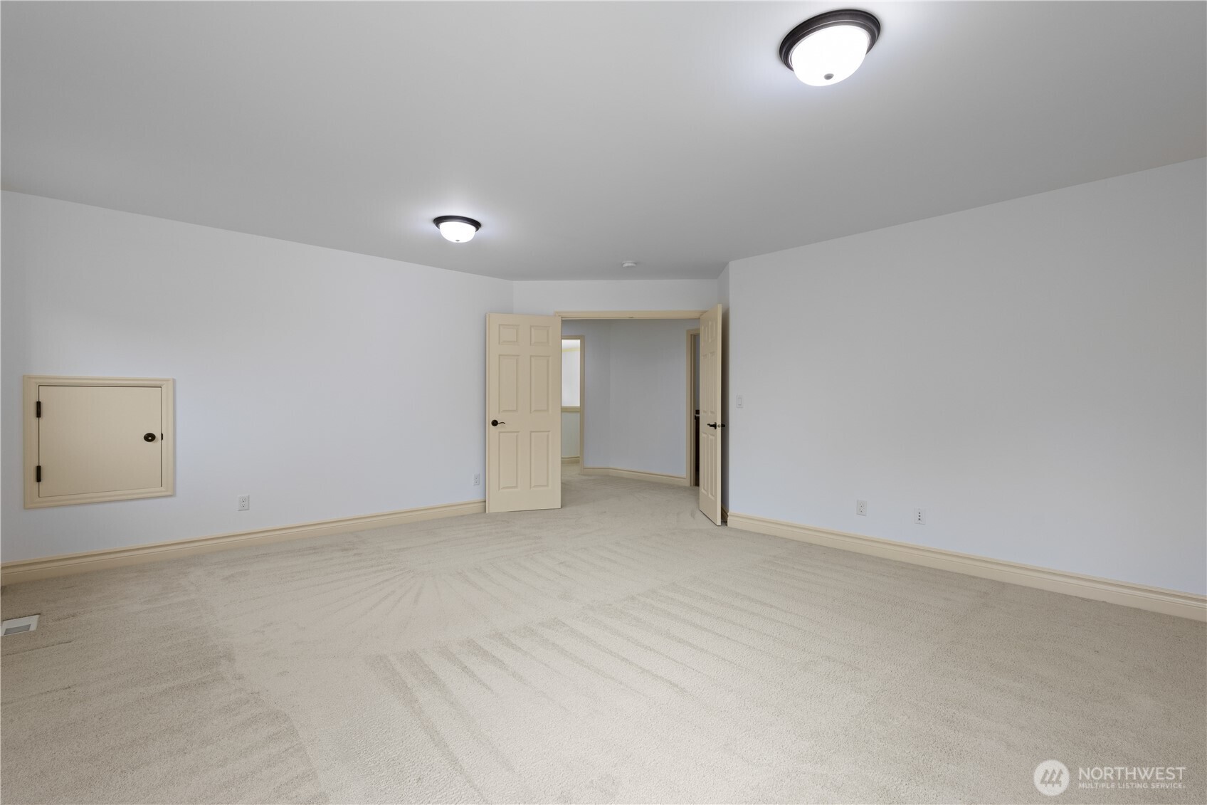 Another view of the bonus room with a double door entry.