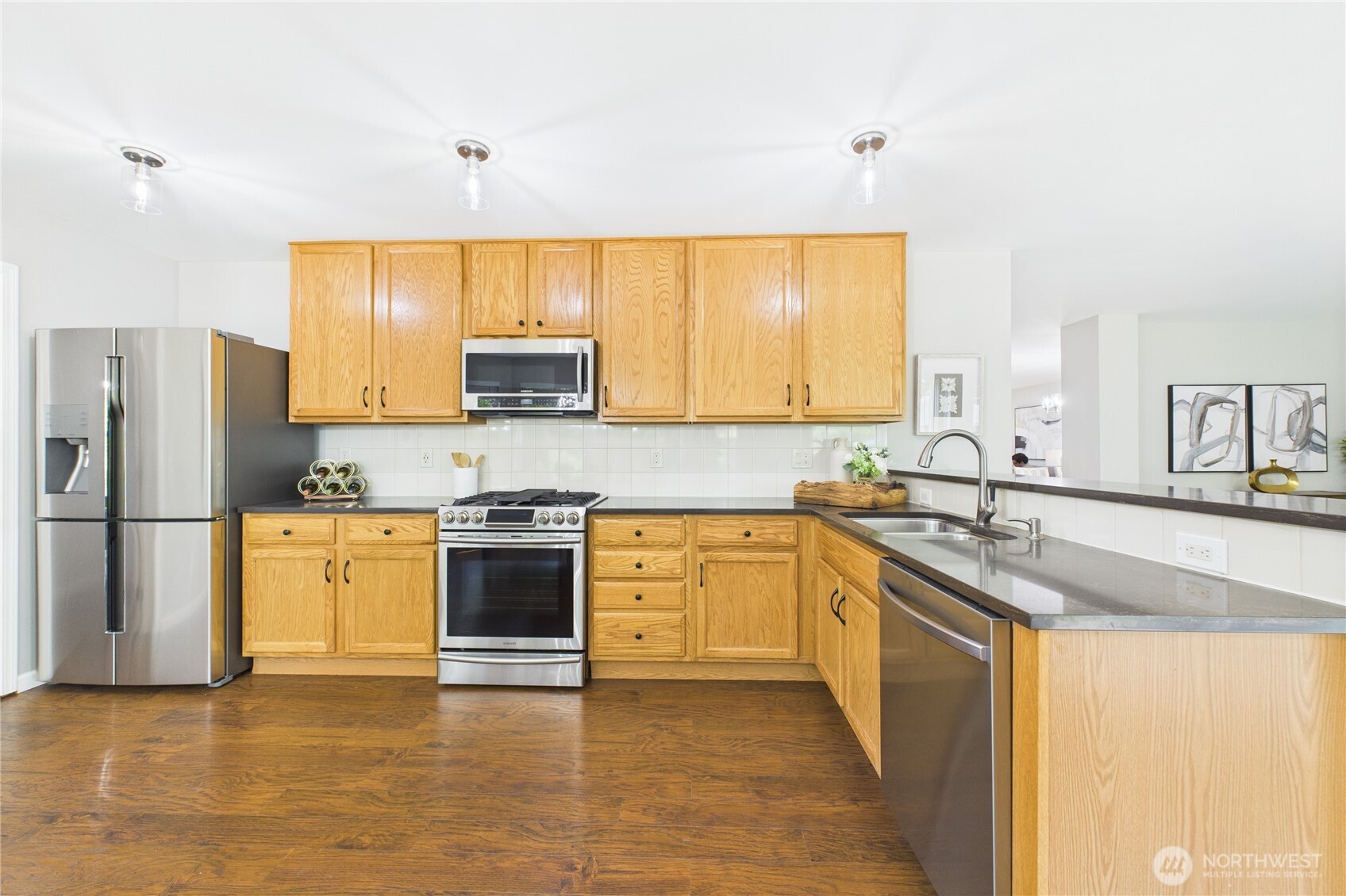 The heart of the home—this open kitchen features solid wood cabinets, updated stainless steel appliances, and sleek granite countertops. With ample storage and prep space, it’s ready for everyday meals and special occasions alike.