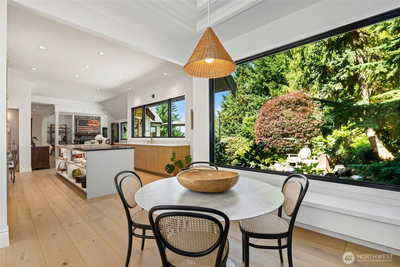 Open-concept kitchen and dining area seamlessly blend modern functionality with natural beauty, ideal for entertaining.