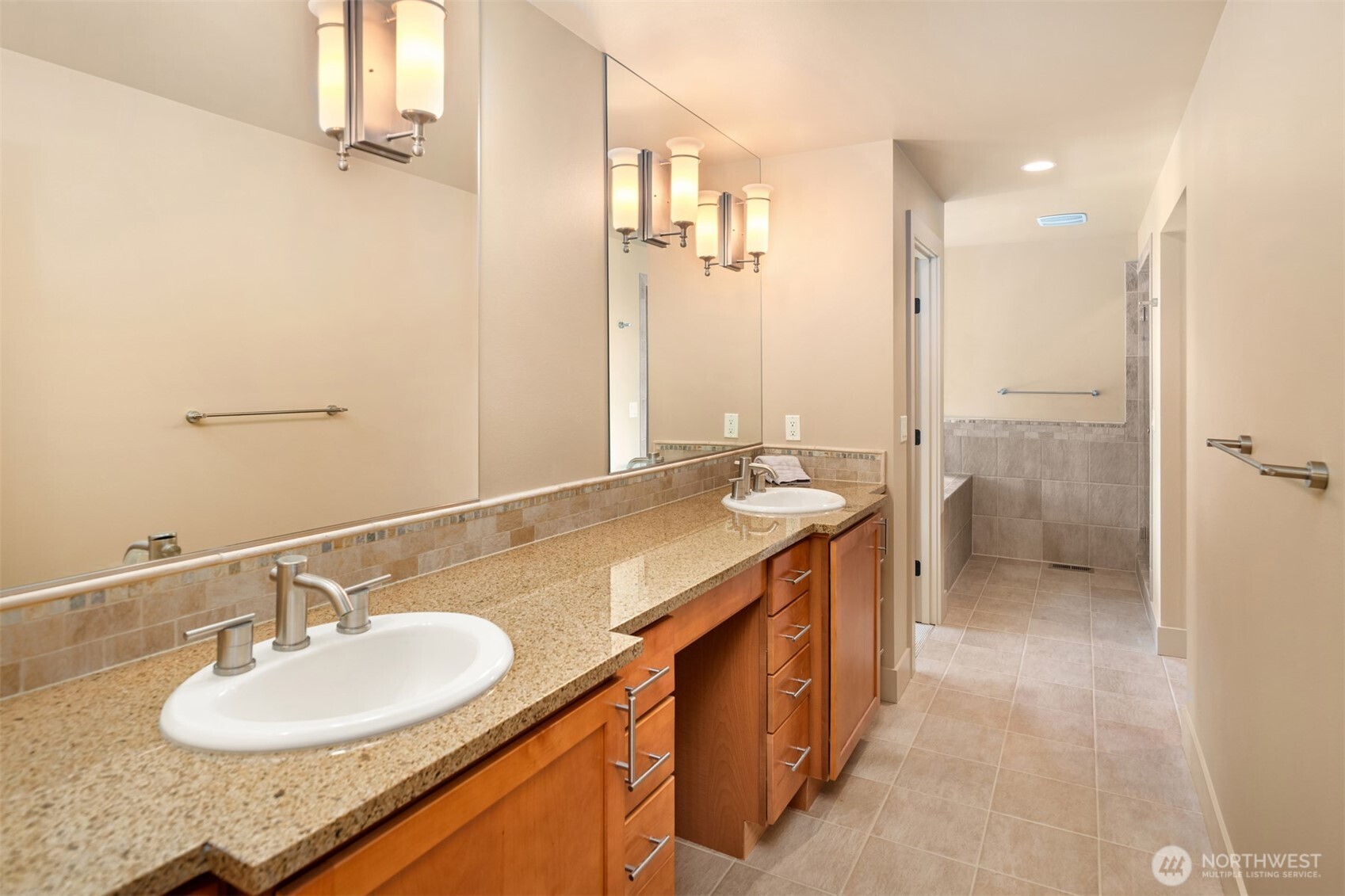 Dual sinks and plenty of counter room, leads to the shower and soaking tub.