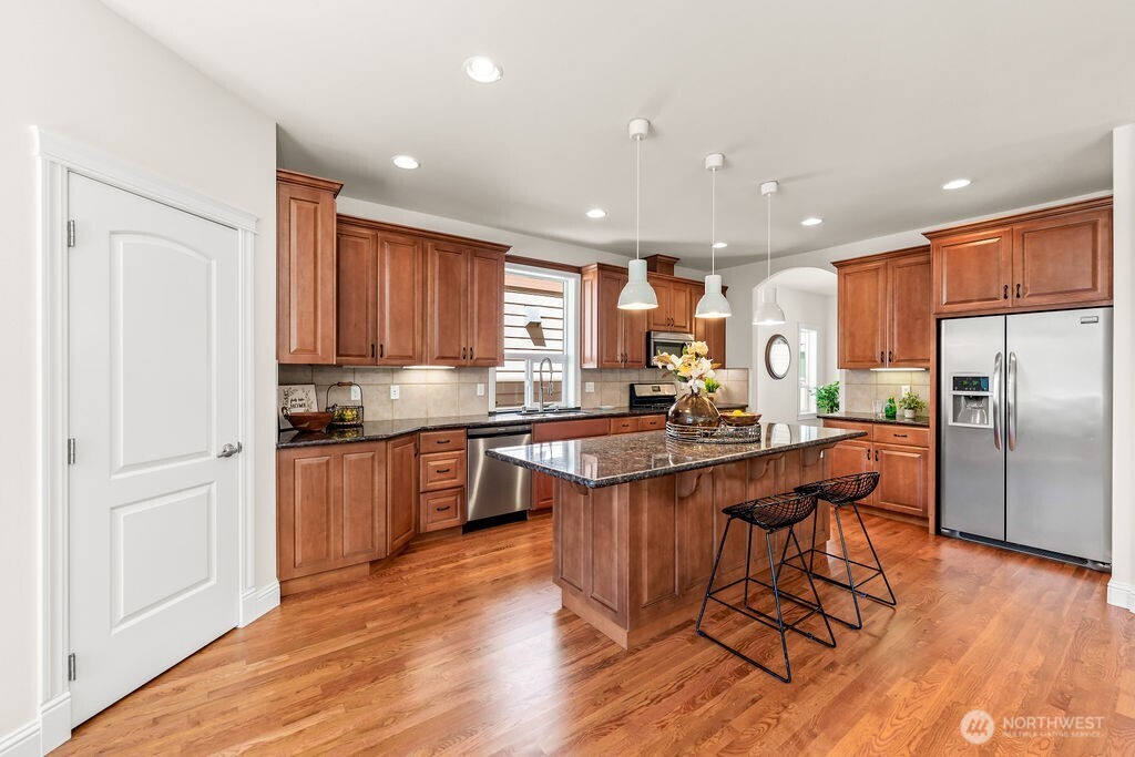 Gourmet kitchen with abundance of high quality cabinets, stainless steel appliances, stand alone island and huge walk-in pantry.