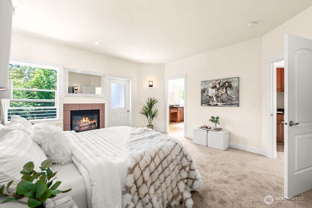Opulent primary bedroom suite on the upper level with the gas fireplace.