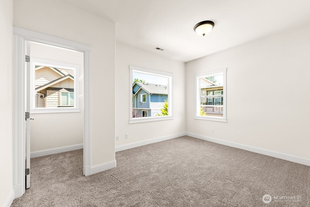 First of two of additional spacious bedrooms on the upper level has a walk-in closet.