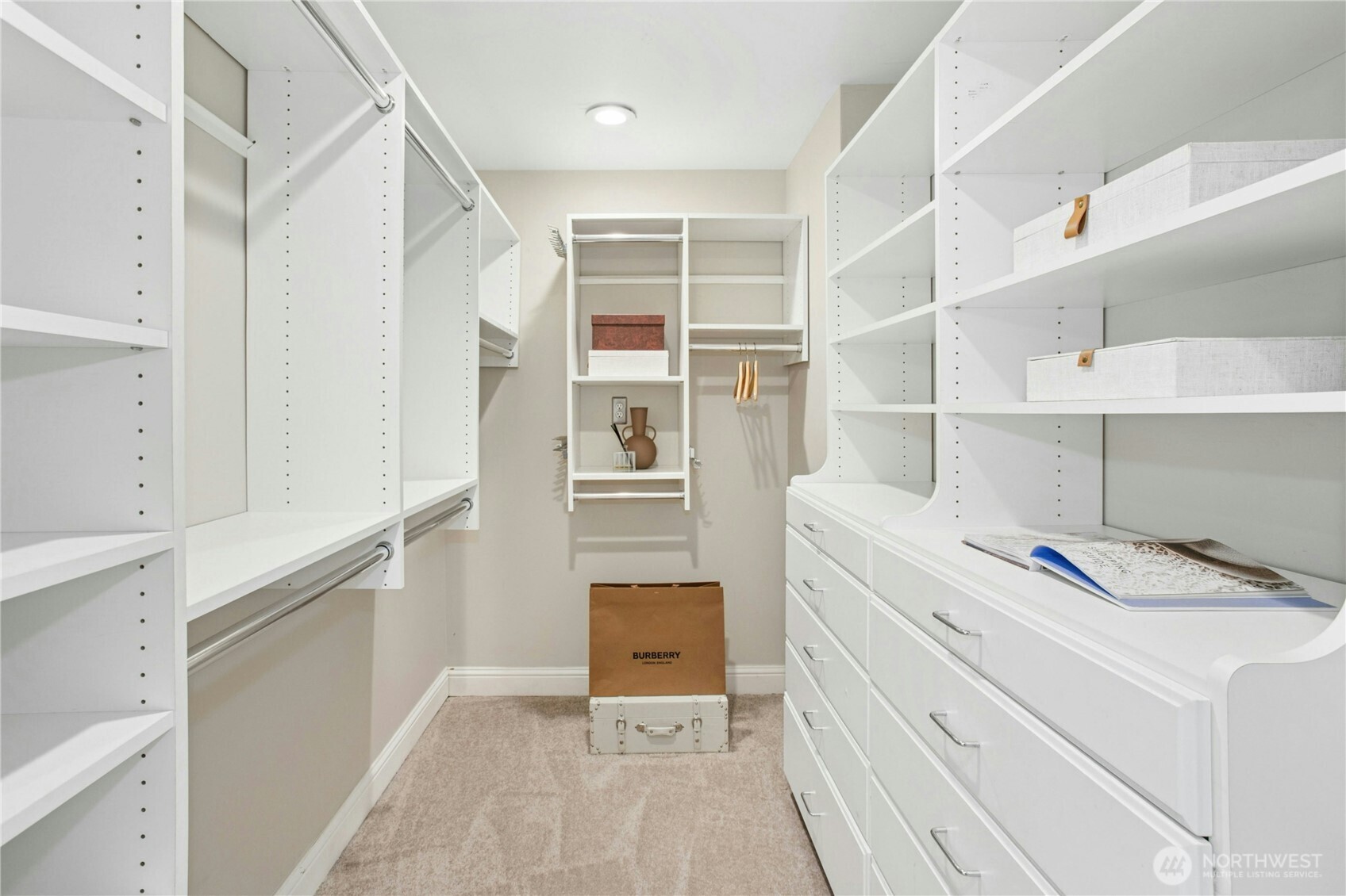 Thoughtfully designed walk-in closet with abundant hanging space, custom shelving, and built-in drawers to keep everything organized and within easy reach.