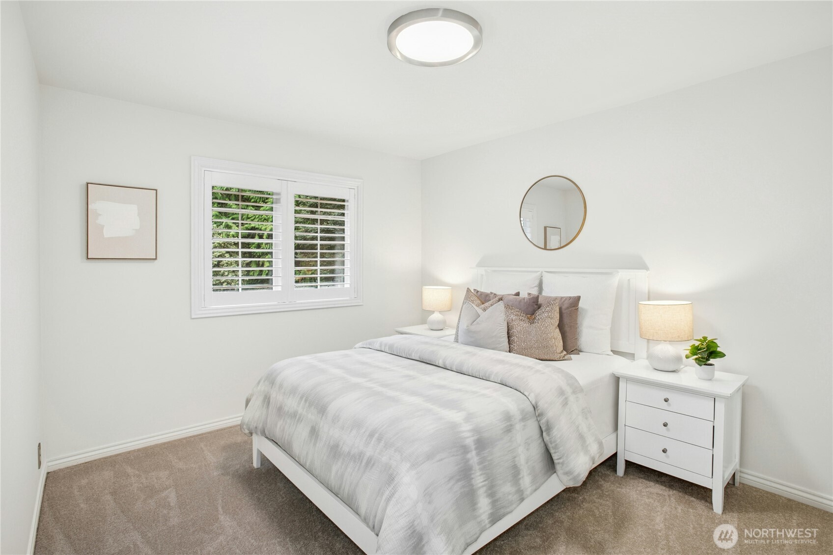 Bright and inviting, this third upstairs bedroom offers calming tones, ample natural light, and a serene view through plantation shutters.