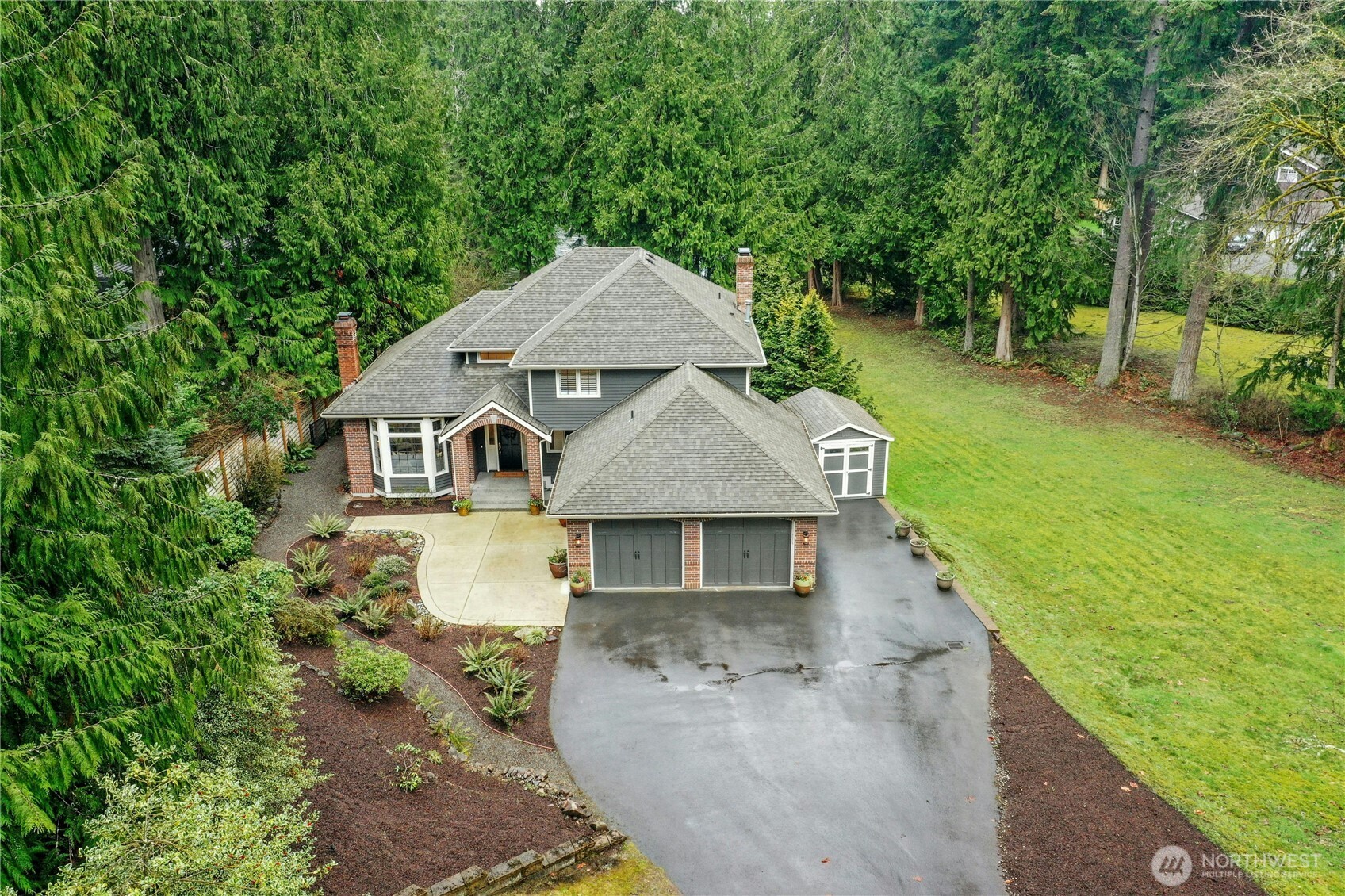 Sweeping driveway approach through lush evergreens - an ideal blend of seclusion and space on a shy acre near Beaver Lake. Only minutes to I-90, shops, schools and other local amenities.