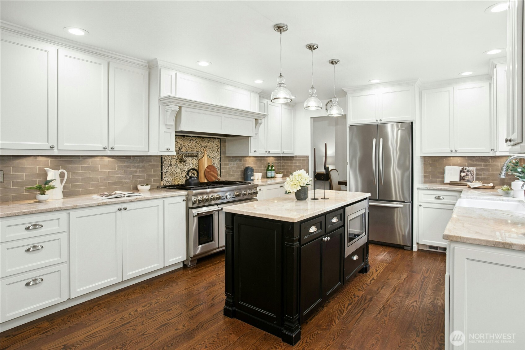 Stunning chef’s kitchen with central island, high-end stainless appliances, custom cabinetry, and views of the lake, thoughtfully designed for lakefront living in Sammamish.