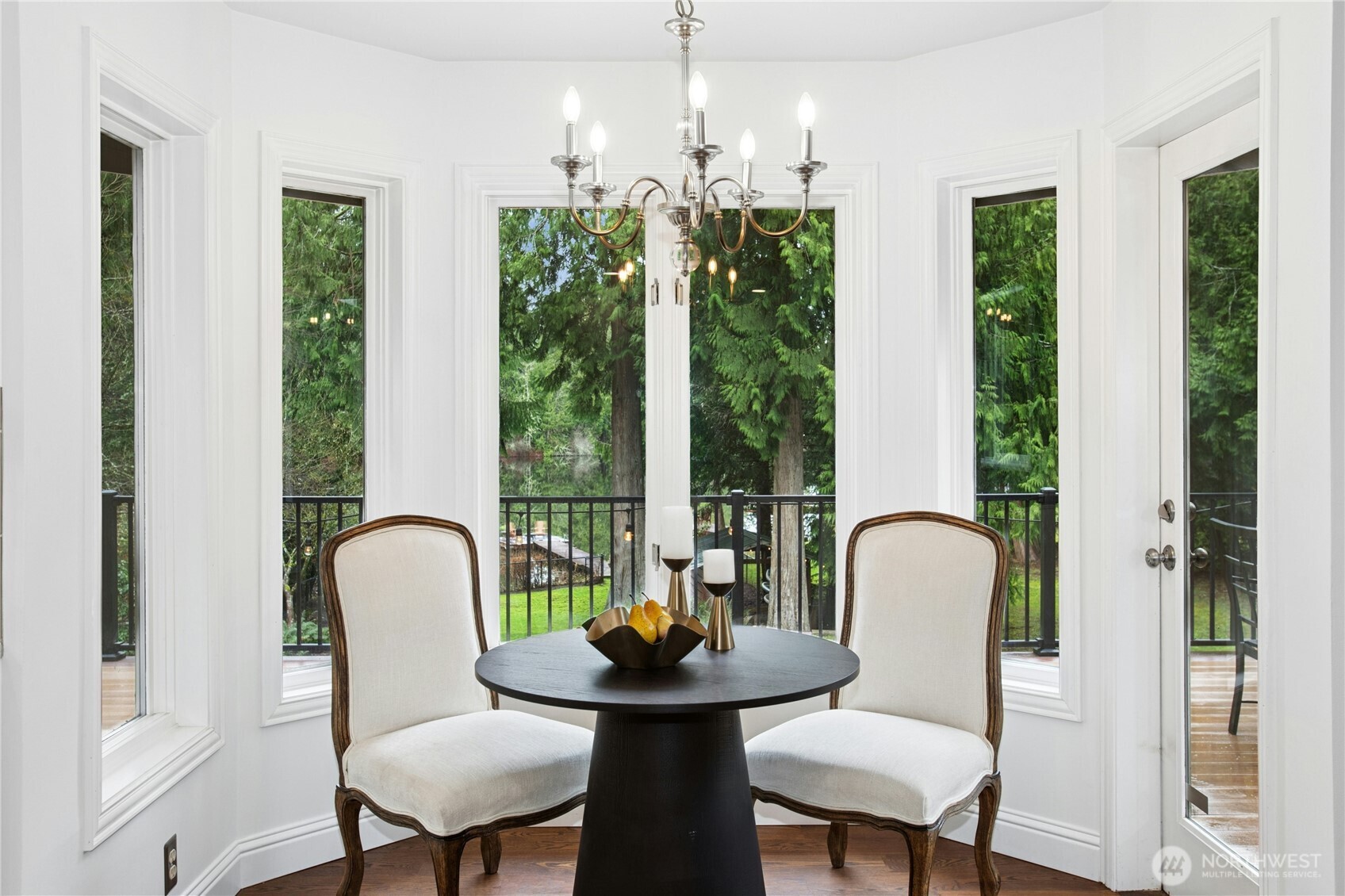 Charming breakfast nook wrapped in windows- enjoy your morning coffee overlooking lush greenery and Beaver Lake.