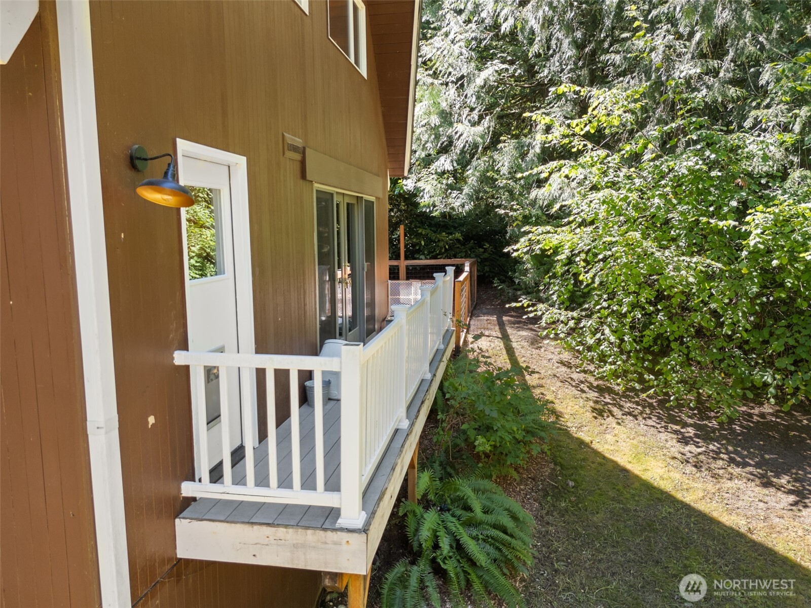 Door off kitchen leads to side deck that opens to the fenced area. While currently used for dogs, this fenced area could also become a garden or fenced play area by removing current wood chips as a solid base was created under the current wood chips.