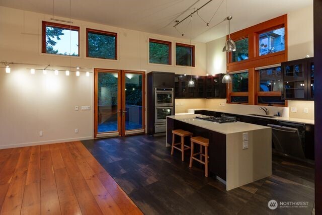 Gourmet kitchen. Tall ceilings with transom windows that offer more light. French doors lead to deck area for relaxing, BBQing. A propane gas attachment is located on deck.