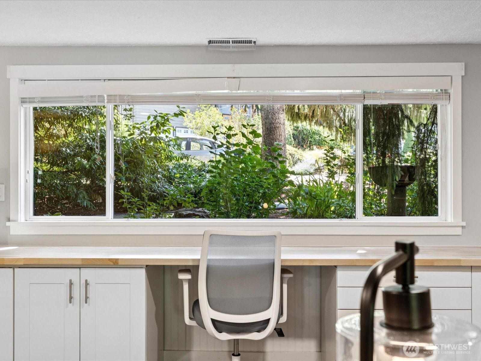 View out windows to front entrance / mature landscaping & offering privacy and filtered natural light