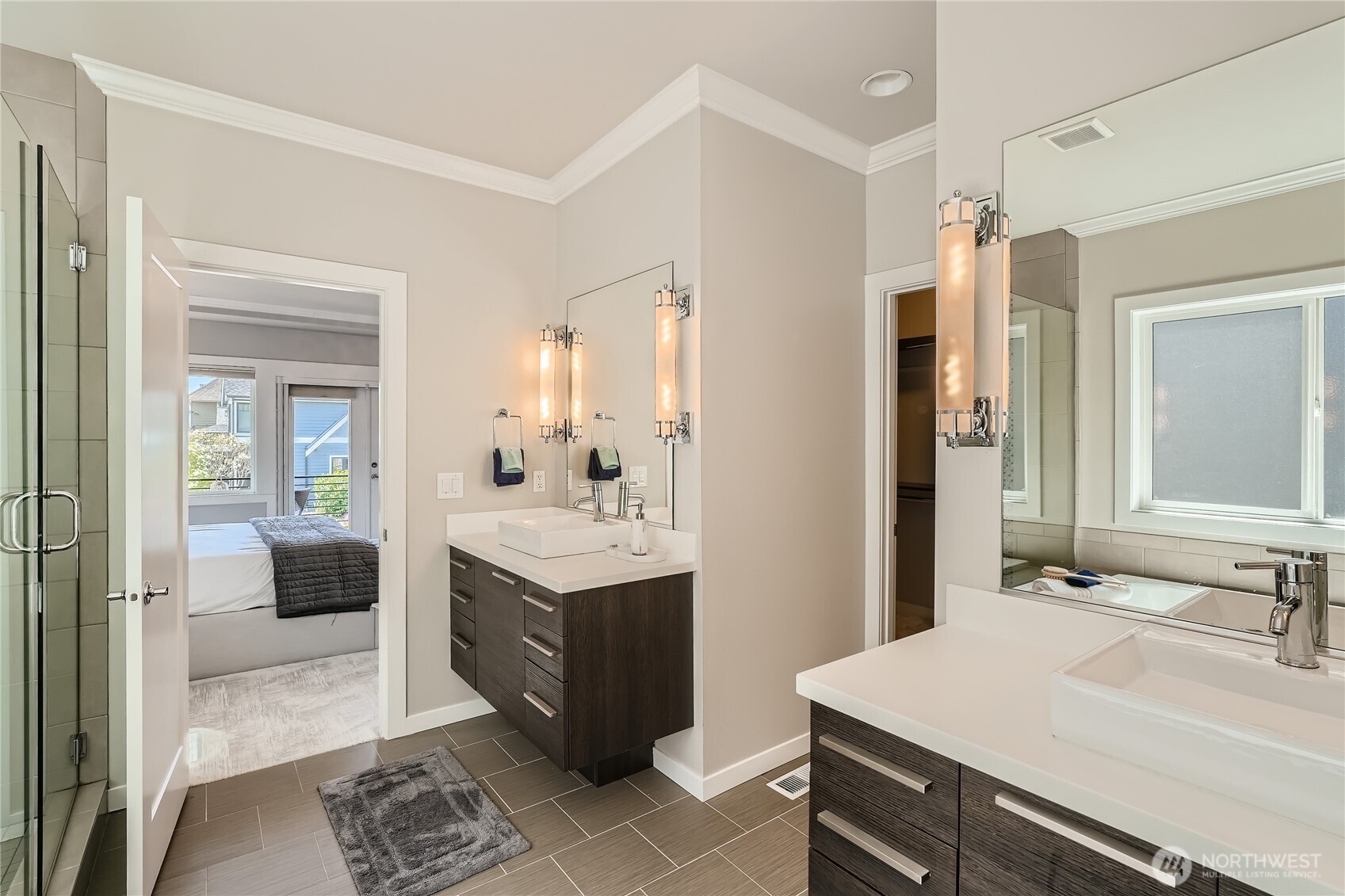 Double vanity en-suite bathroom with large built-in closet.