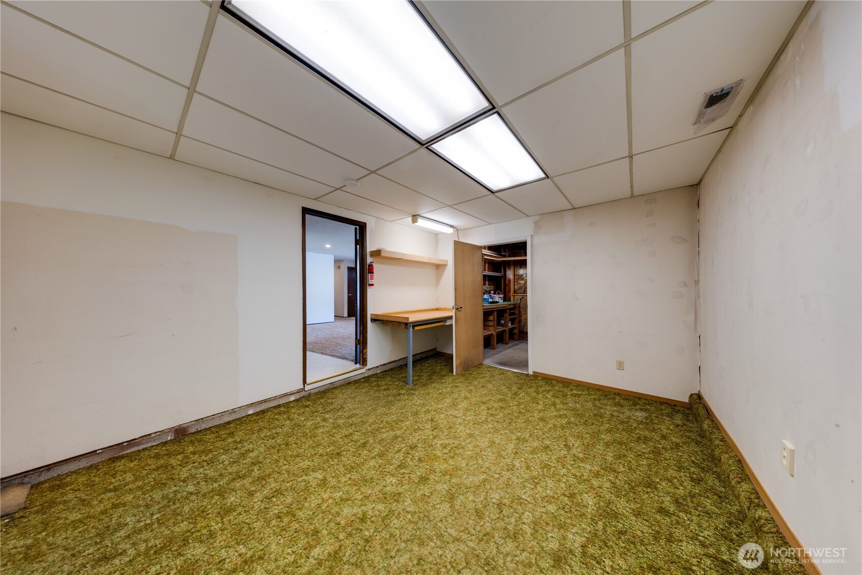 Office/hobby room off dining area.  Door to additional shop room