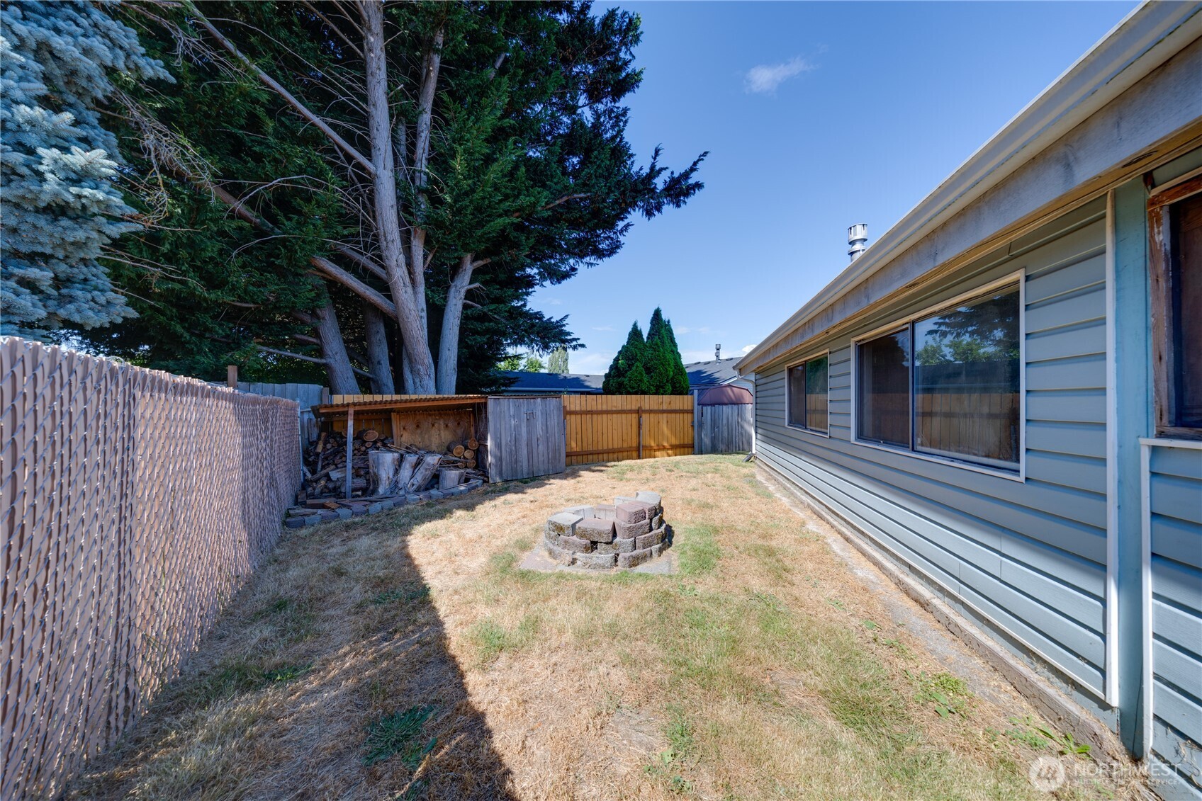 Backyard has a firepit & wood shed