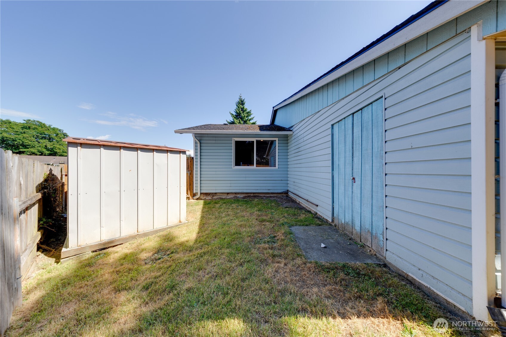 Back/side yard has another outbuilding plus a garden shed