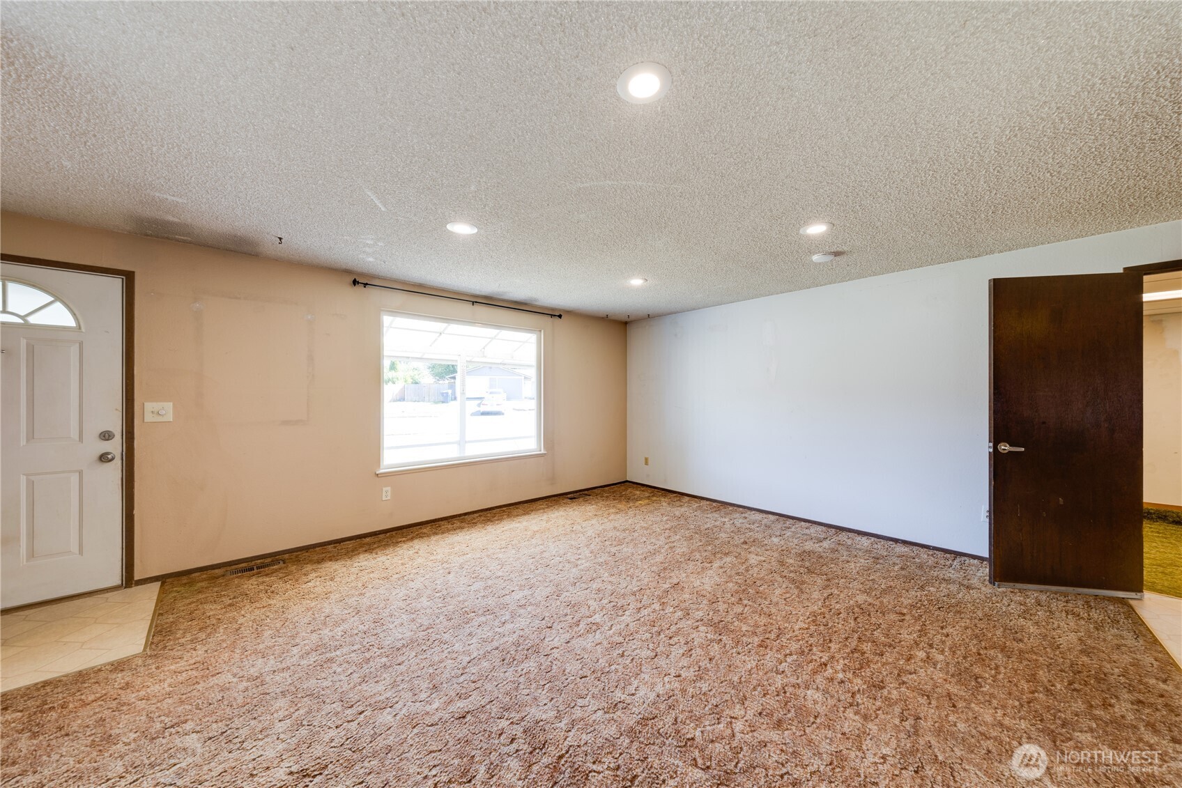 Another view of the living room.  New owner can give it new paint & flooring