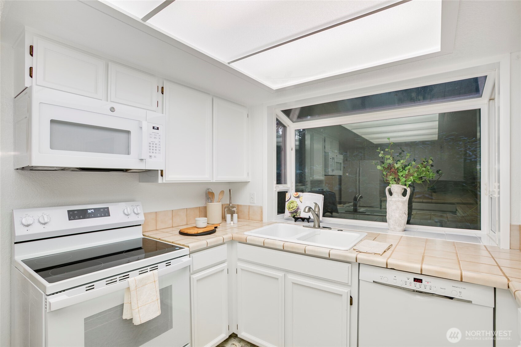 kitchen opening to casual dining area & den w/ backyard access
