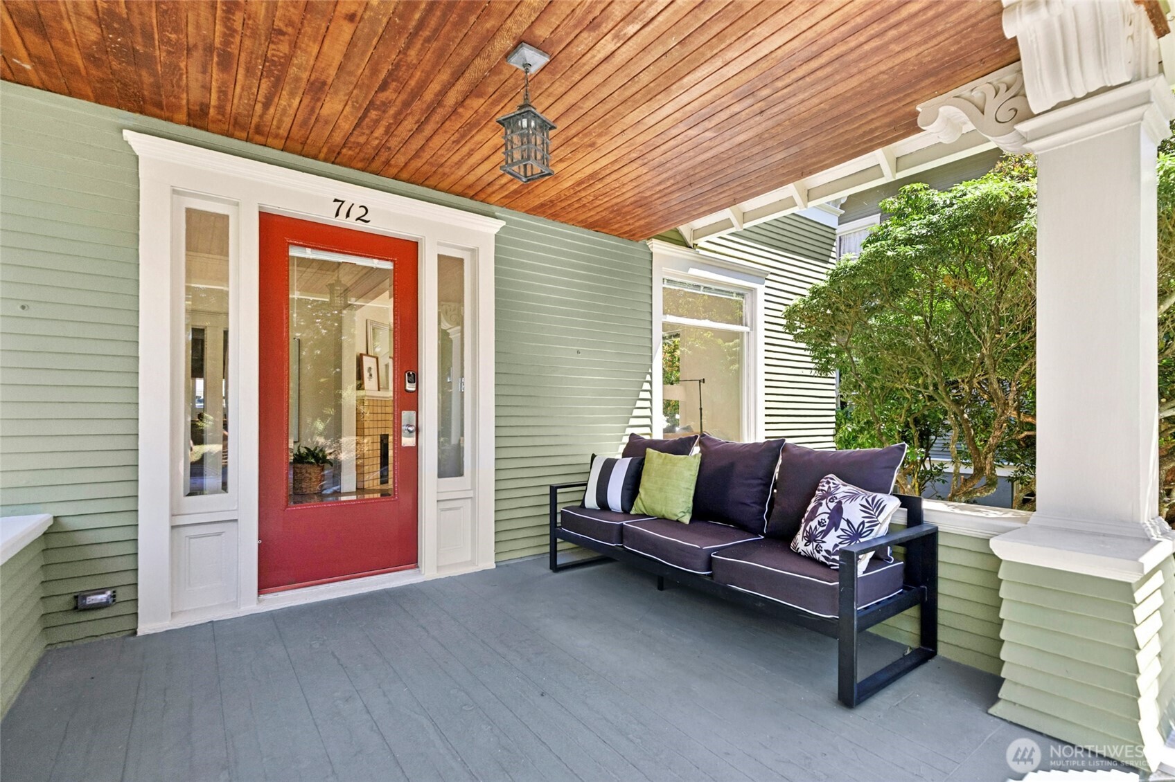 Covered front porch with original bead board ceiling and stately pillars.