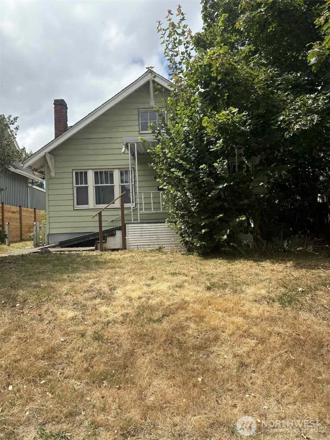 Set back off the street, with a beautifully restored home next door, this home could be next! SO much potential!