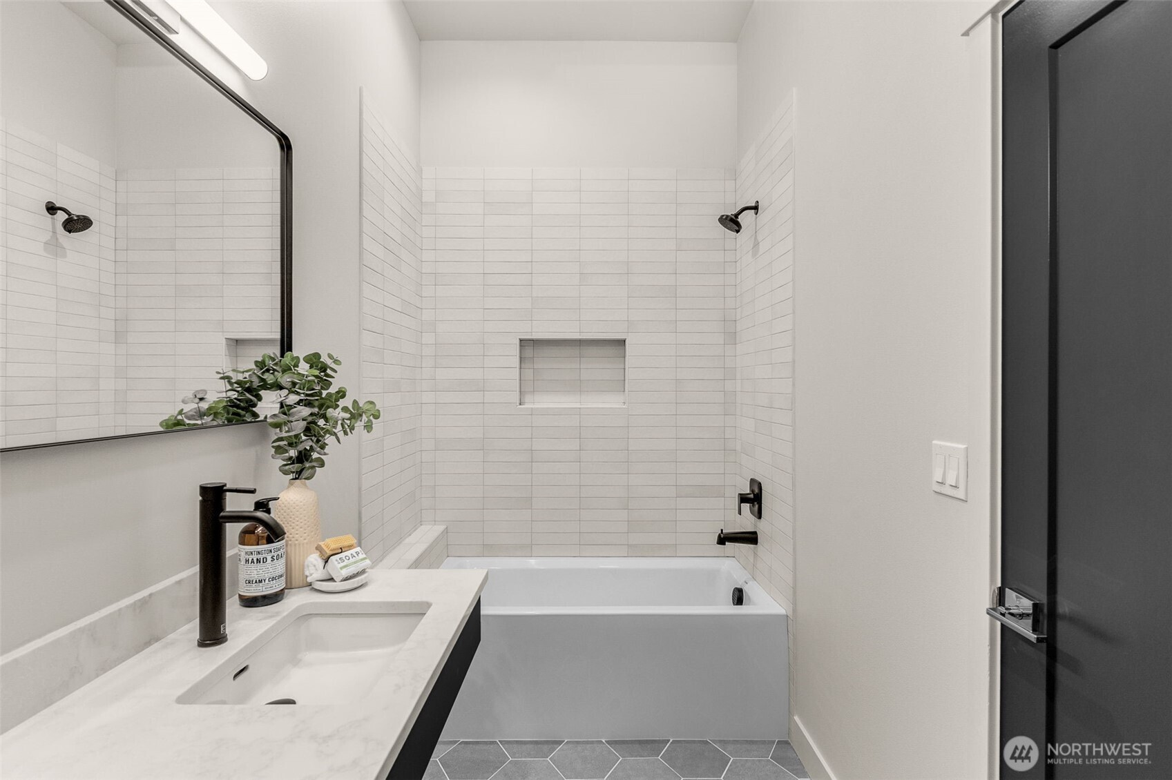 Crisp lines, floating vanity, and contemporary lighting create a streamlined second bathroom that complements the home’s overall aesthetic.