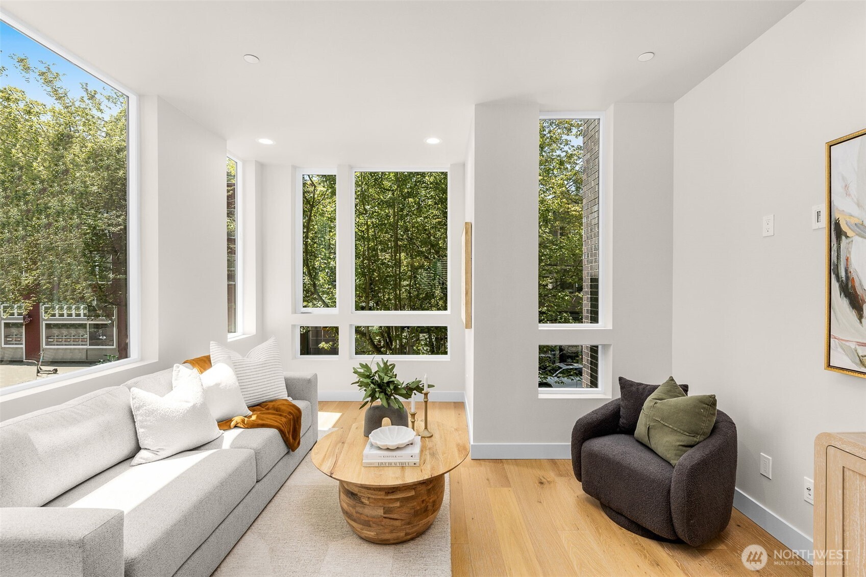 Window-lined living space is basked in a calming natural light and gives the sense of "floating" amongst the trees