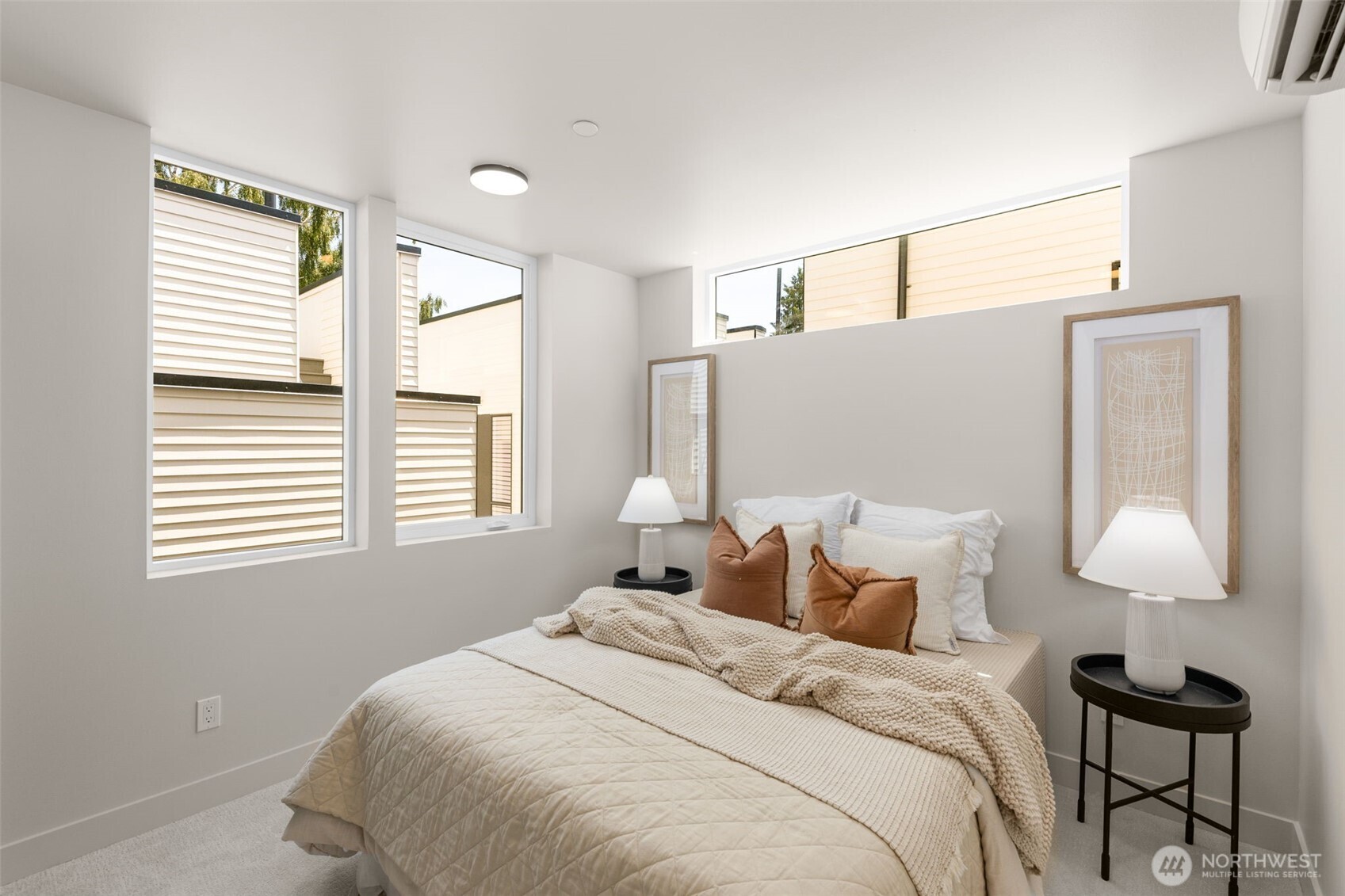 Light-filled bedroom with calming finishes and a modern aesthetic.