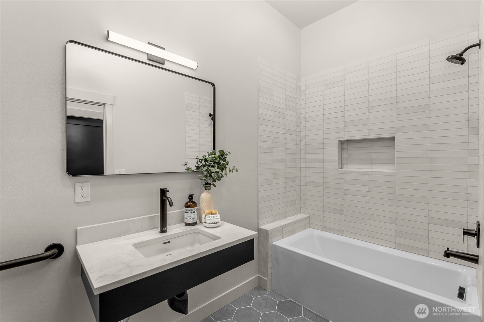Spa-inspired bath with floor-to-ceiling tile and walk-in shower.