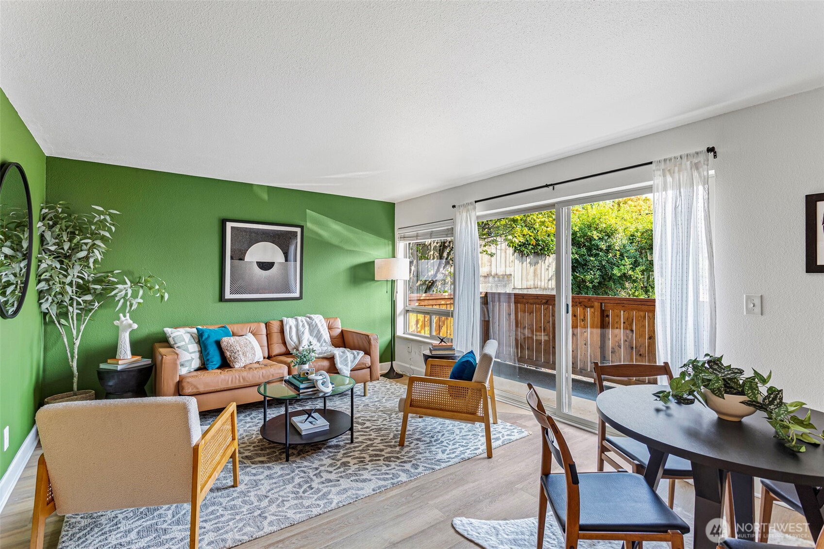 Light filled spacious living room with glass slider to private patio