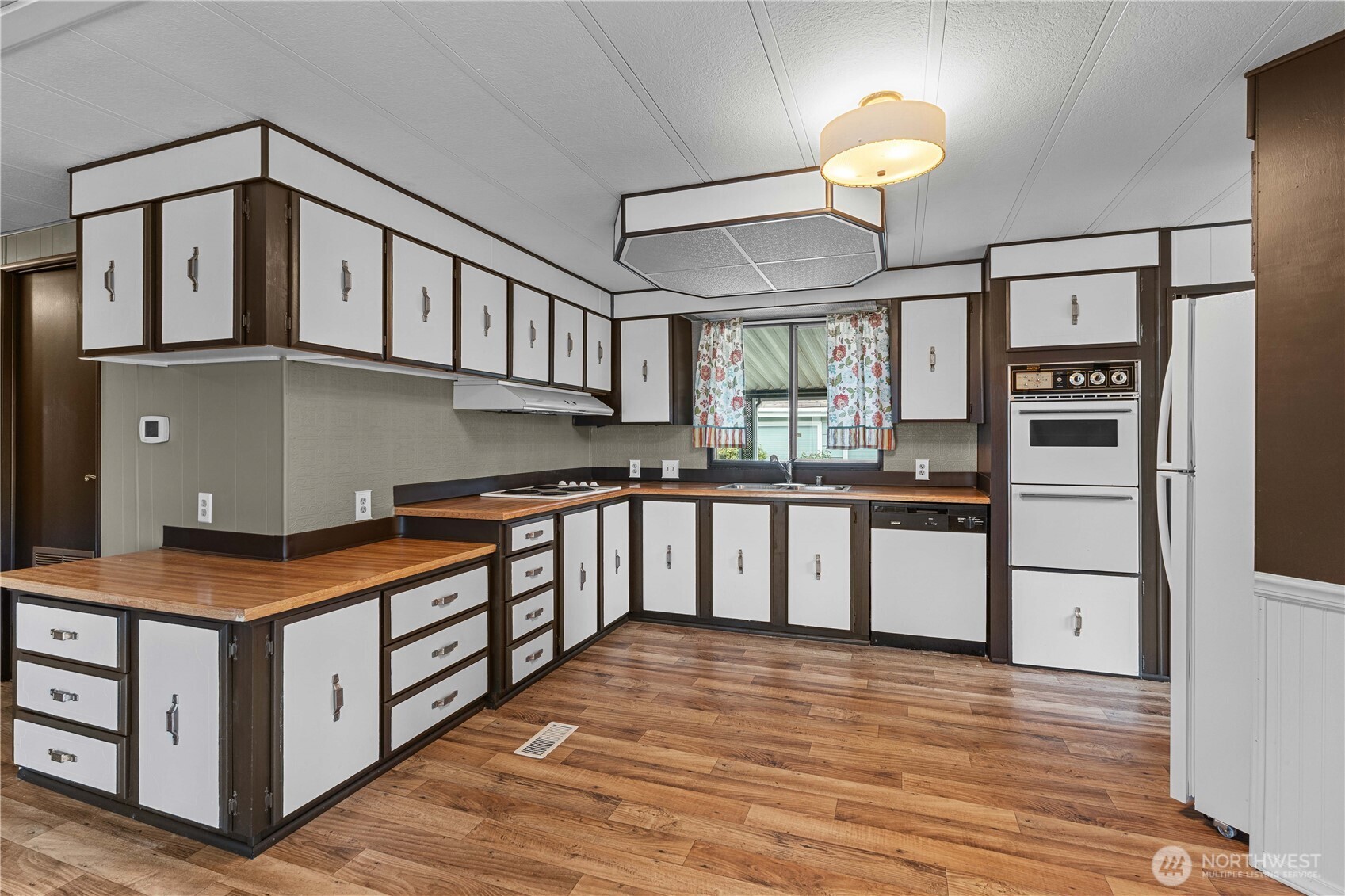 Kitchen has tons of cabinets, lots of counter space, new flooring, and all appliances stay.