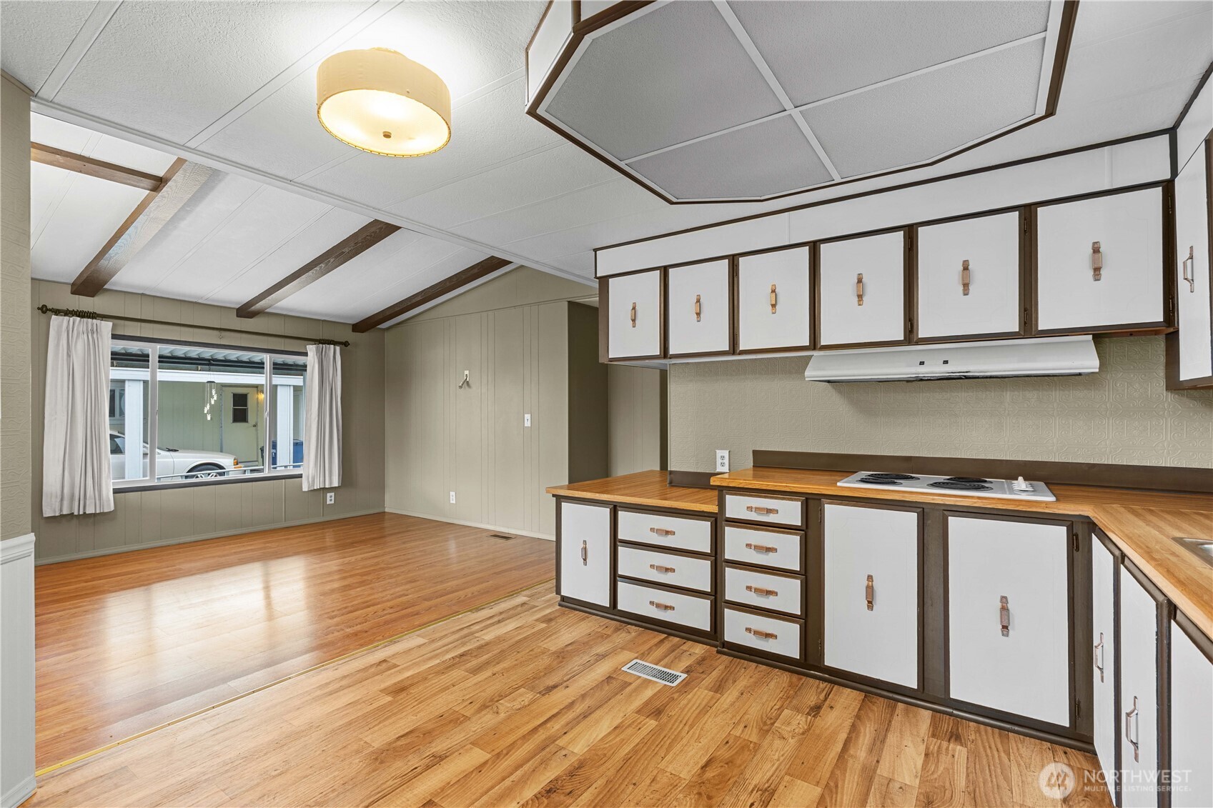 Kitchen looking into additional seating/living area.