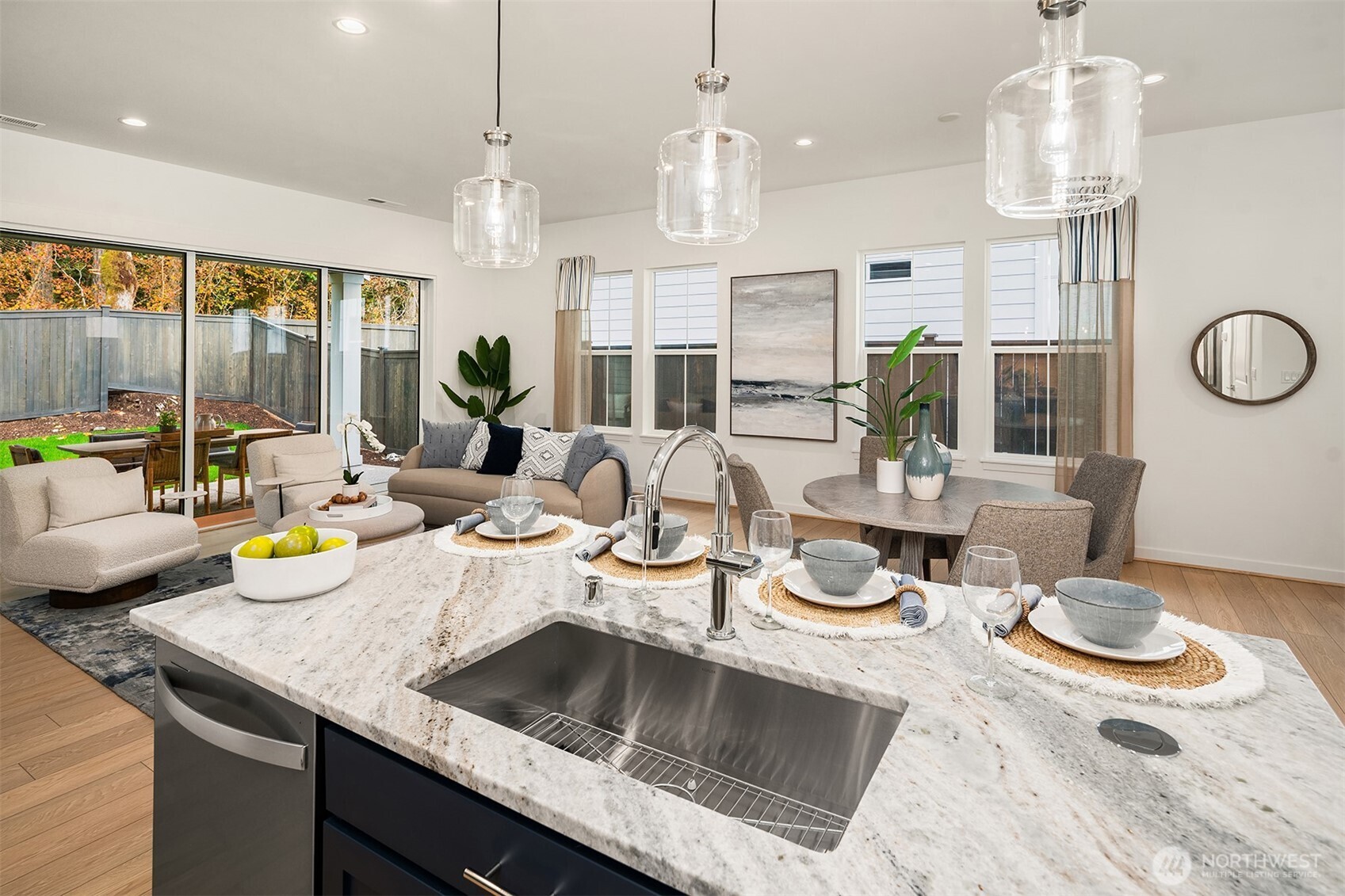 Light and bright kitchen open to great room space and dining area