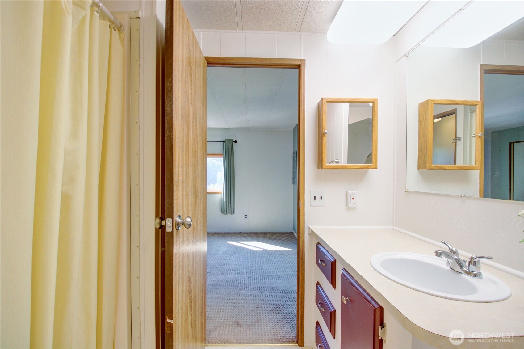 Shower is to the left with storage behind the door.