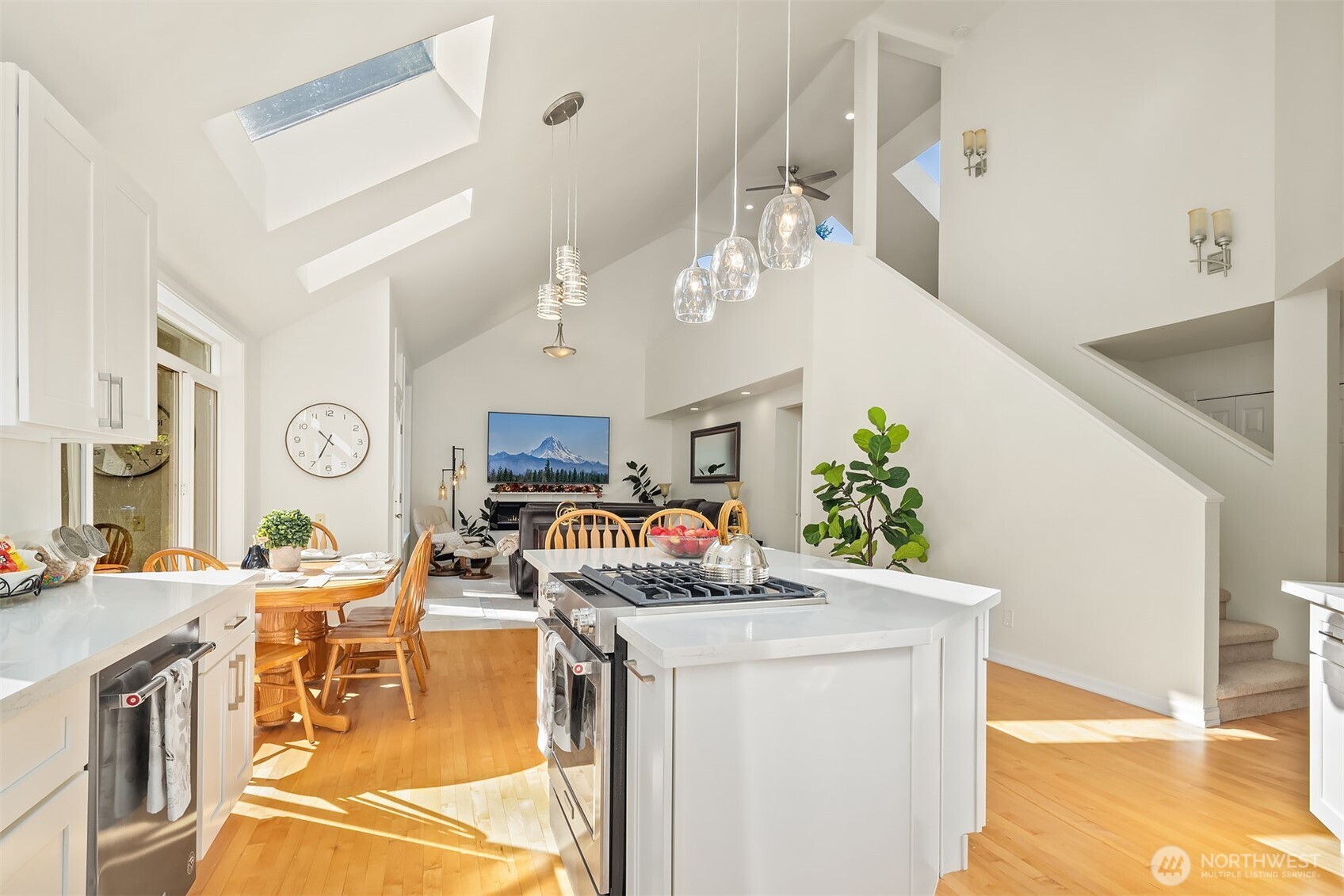 Experience the heart of the home with an open-concept gourmet kitchen and family room featuring 25 foot vaulted ceilings, luxurious new carpets throughout, rich hardwood floors, built in fireplace, custom lighting and expansive windows and all five new skylights flood the space with natural light year round.