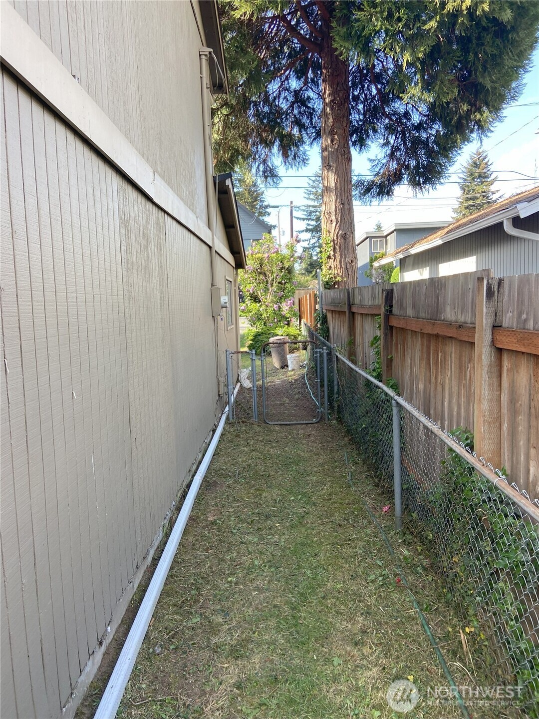 Follow the pathway on the east side of the house (to left of garage looking at house from the front) around to the huge backyard!