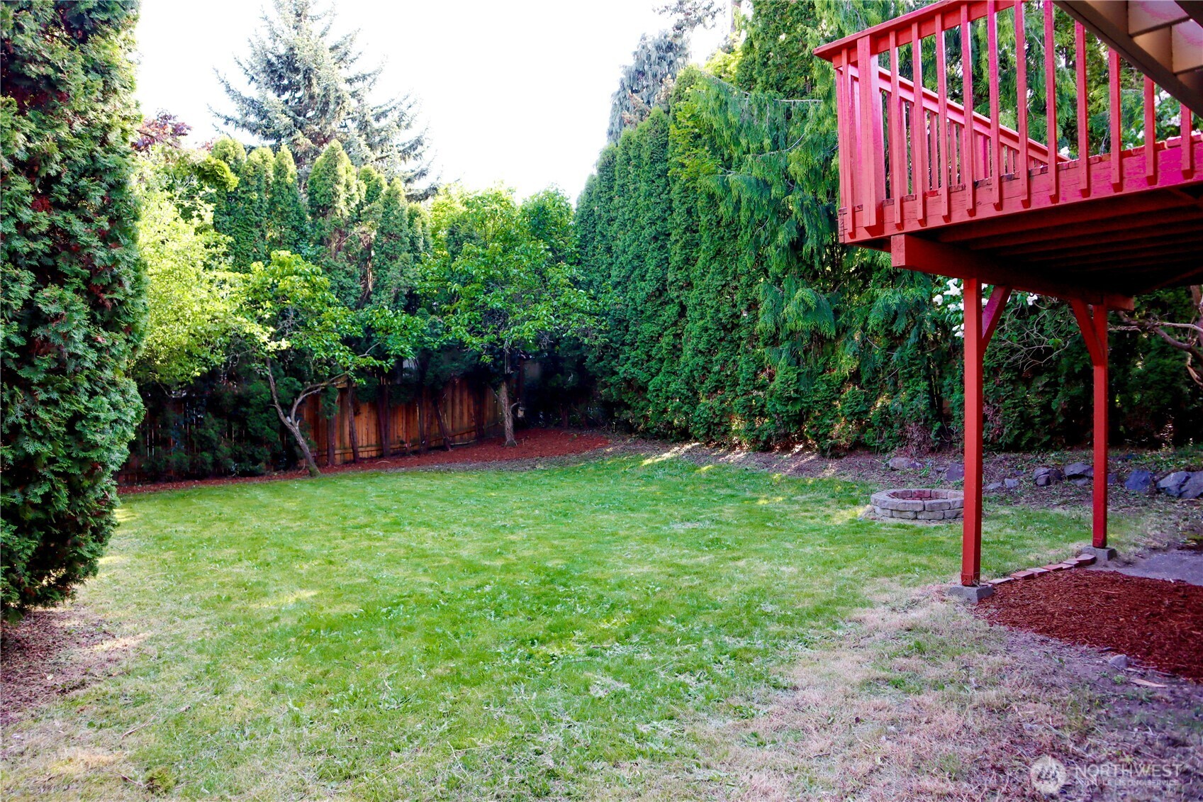 There is a pathway on the east side (from front of home, on the left side) leading to the backyard. Deck is accessible from kitchen/dining.