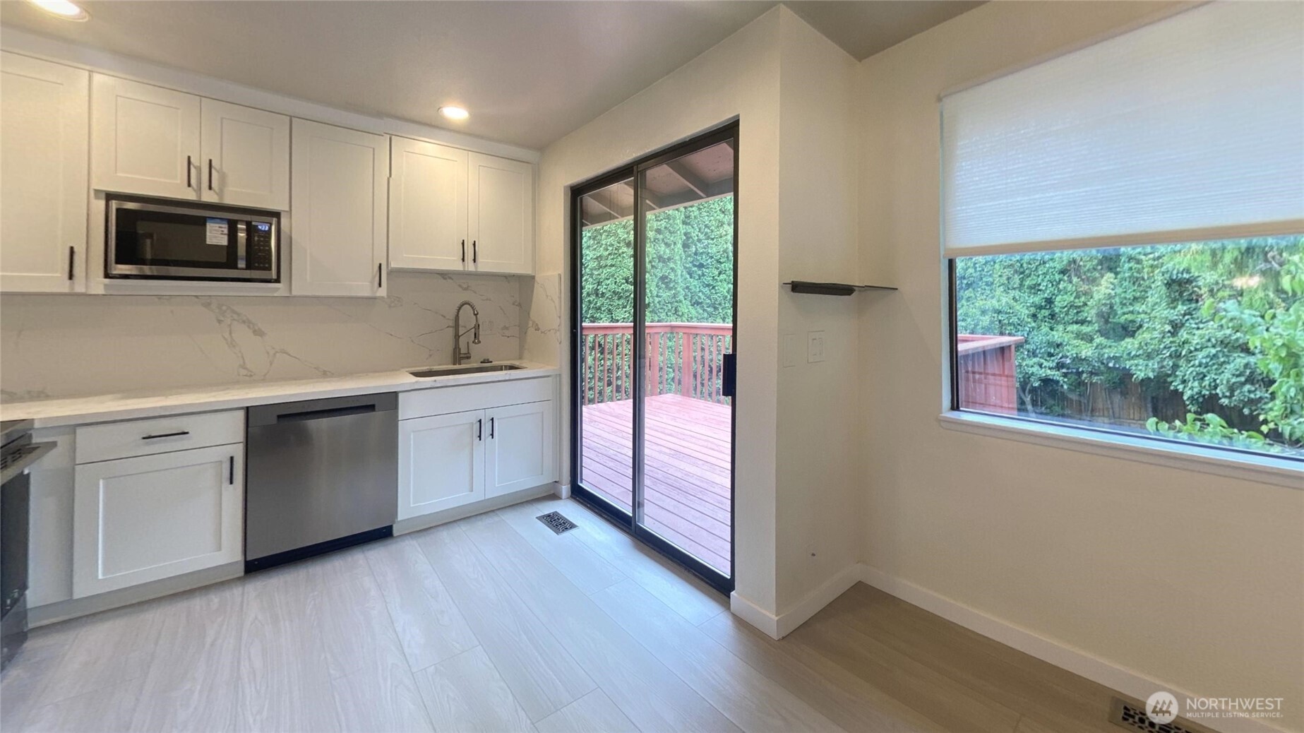 Looking from dining room through kitchen to back deck.