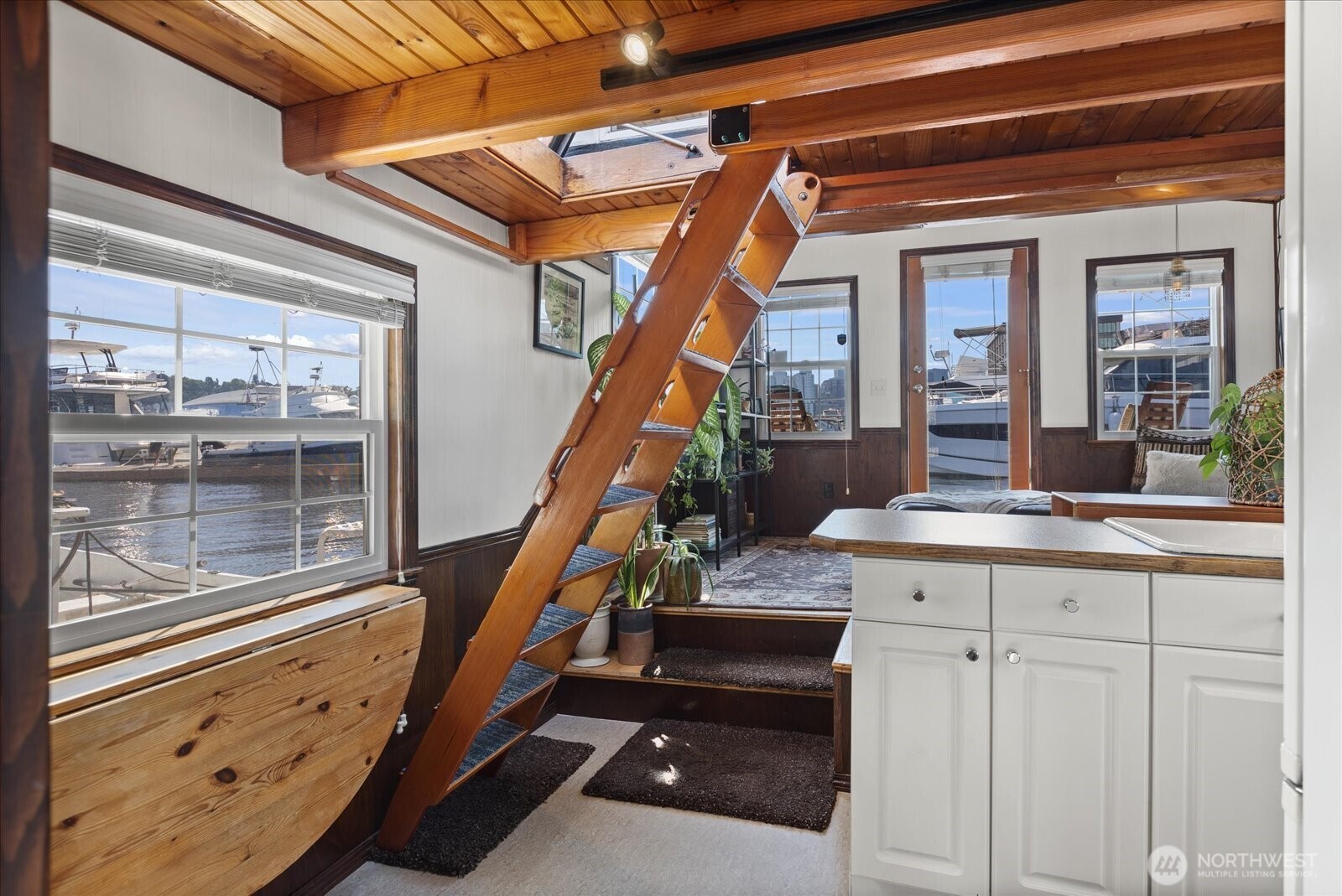 Ladder to roof deck that folds up when not in use