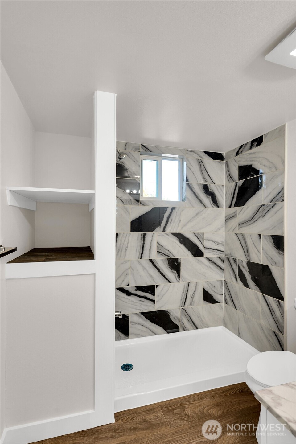 Spacious primary bath with thoughtful storage solutions.