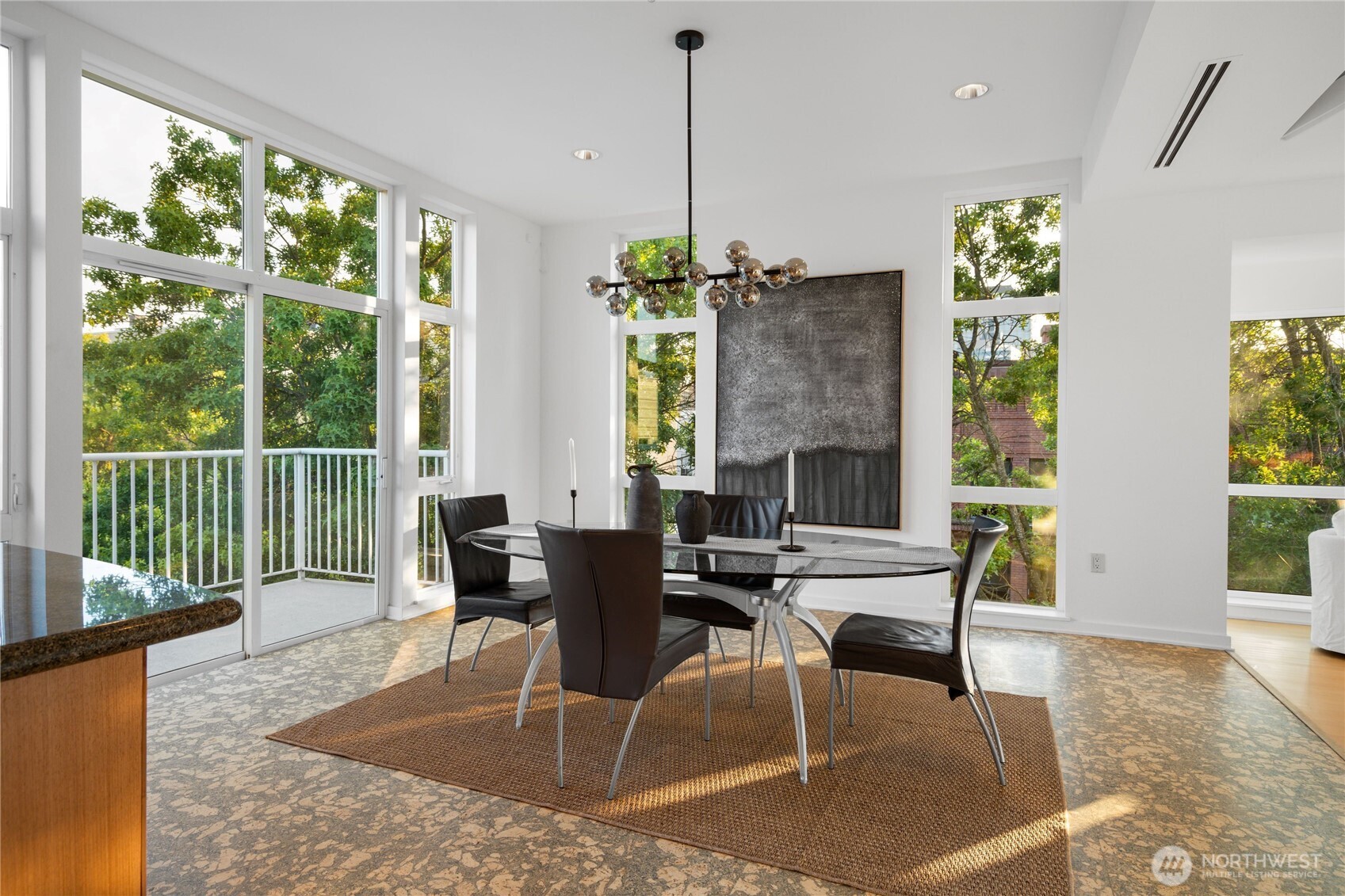 The dining area opens directly to a balcony.