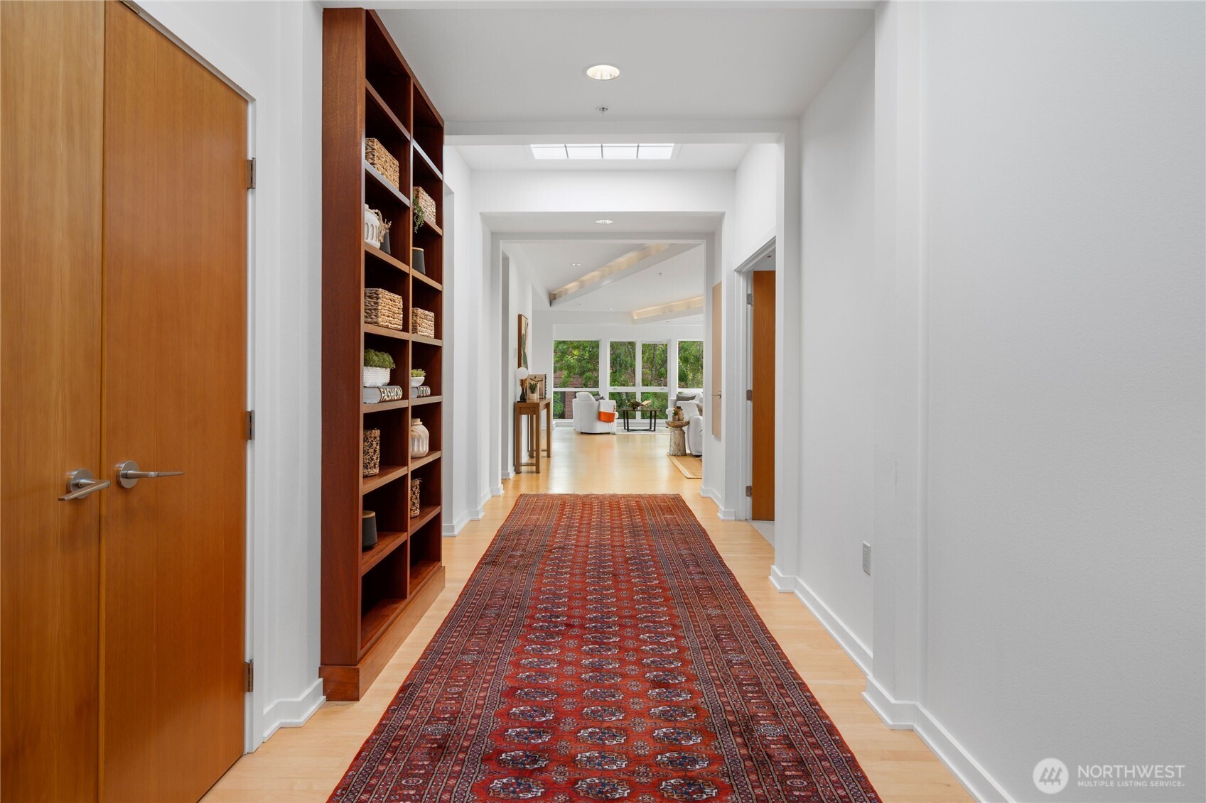A dramatic entry sets the tone, flanked by custom built-in bookcases complimented by an oversized coat closet.