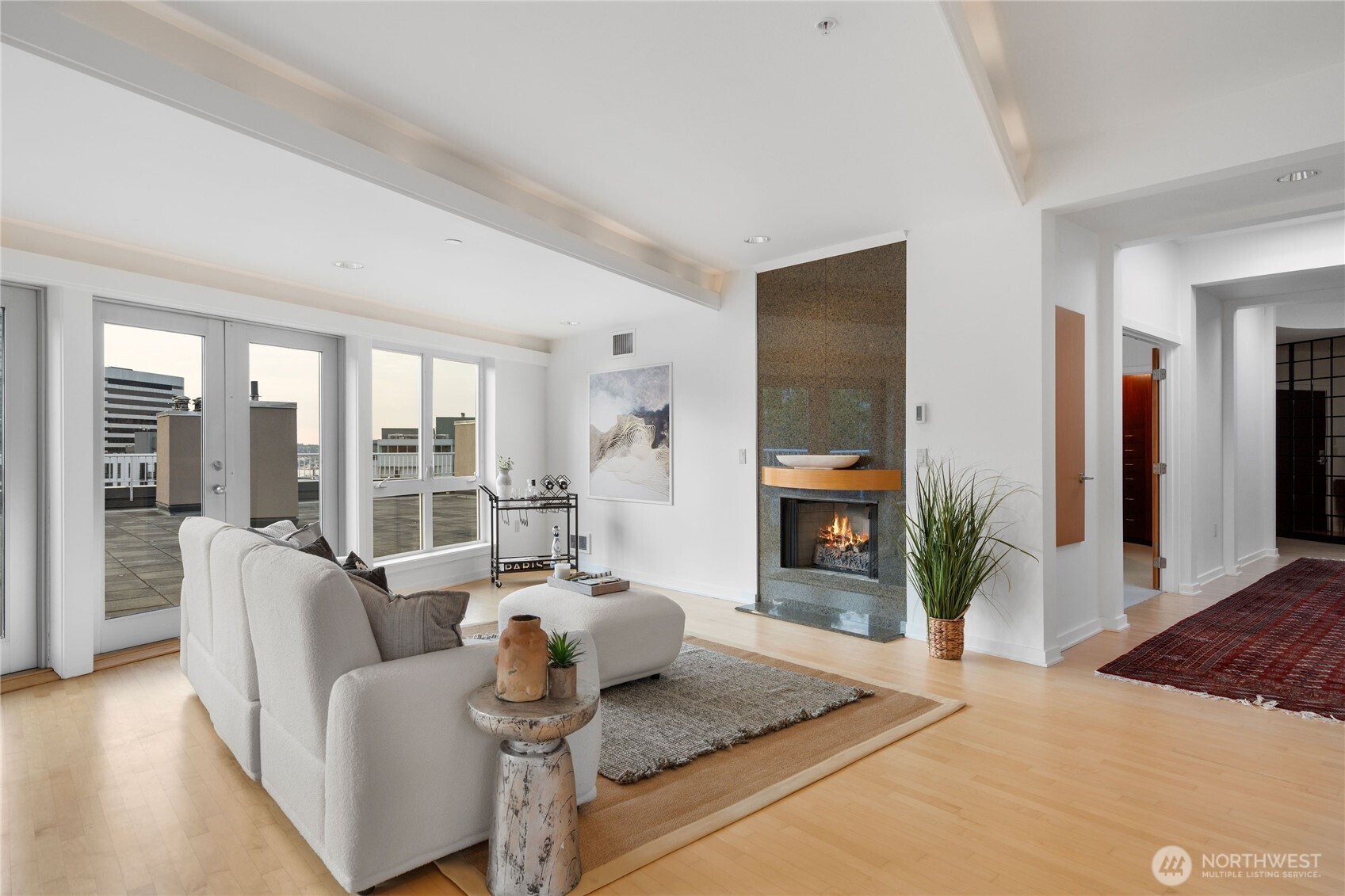 The living space expands seamlessly to the expansive terrace by way of  French doors.