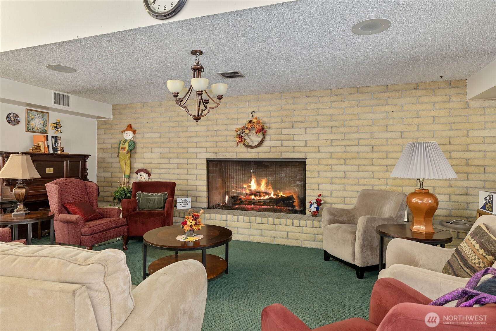 Clubhouse fire place meeting area, also has commercial kitchen, large dining area, recreational room and library area, plus outside entertaining and pool.