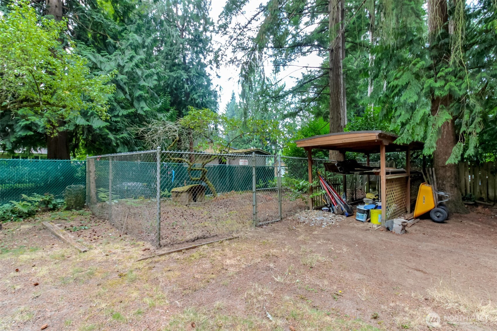 Built-in, chain-link Dog Run and covered boat storage or carport