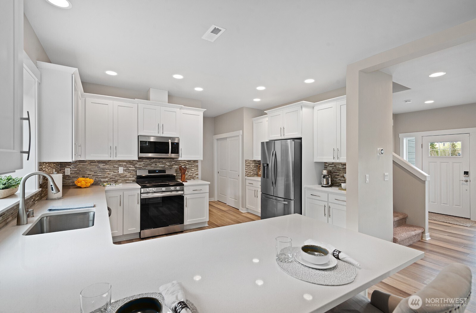 Chef's kitchen with gas range, coffee bar, ample kitchen storage and counter space.