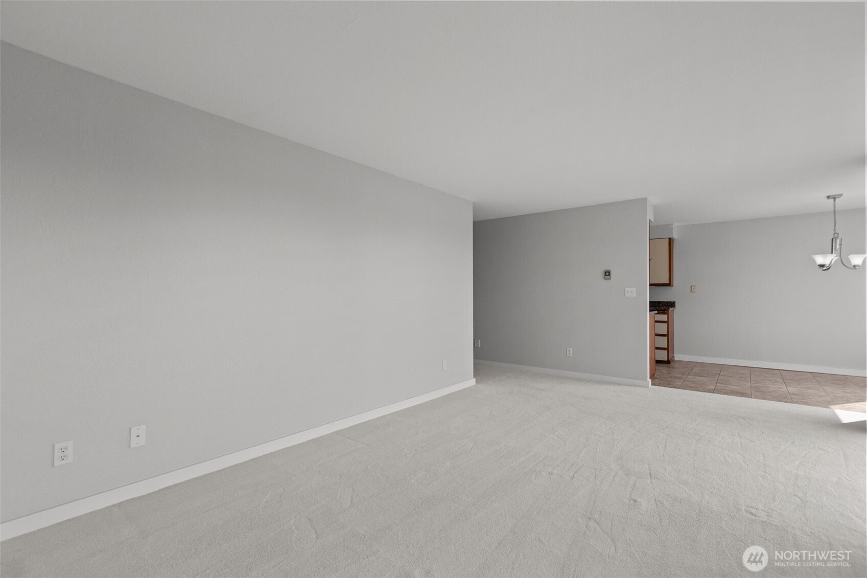 Bright open living room with cozy wood-burning fireplace and large windows